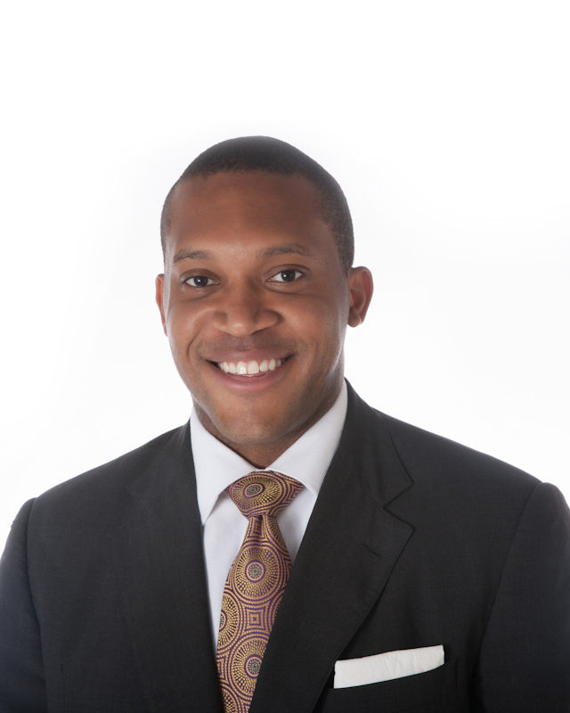Young black professional in suit and tie takes headshot in Loudoun County